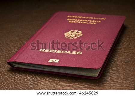 german travel passport with biometric chip symbol on leather background