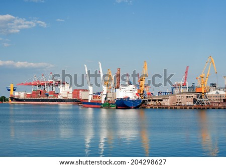 Loading at the port. Ships at sea for loading. Cranes and containers. Cargo sea port
