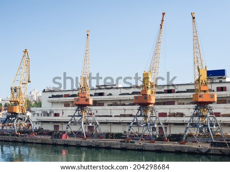 Marine cranes in the port for loading cargo. Dock at the seaport