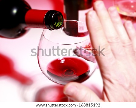 Closeup photograph showing alcohol consumption focus on the neck bottle and glass of wine;