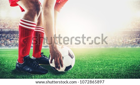 red team soccer footballer get the ball to free kick or penalty kick during match in the stadium