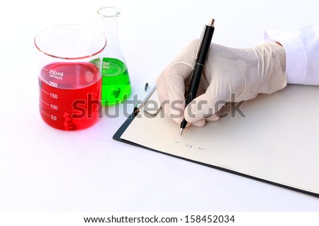 Scientist recording chemical data.