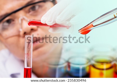 Pipette adding red fluid to test tubes,laboratory concept