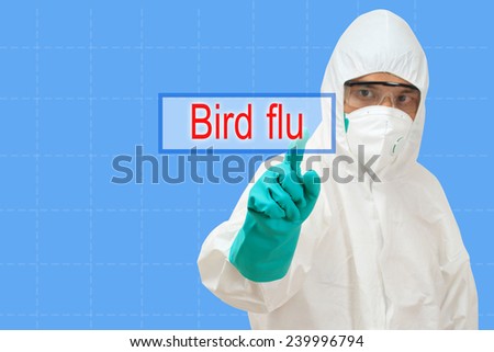scientist in safety suit  pointing to bird flu
