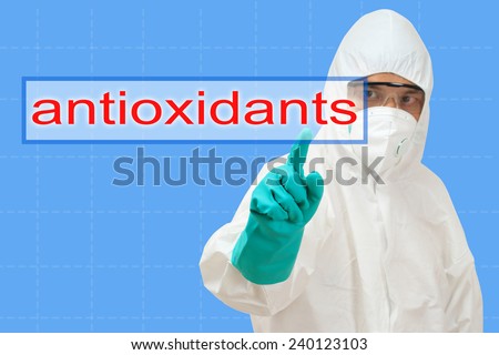 scientist in safety suit pointing to word antioxidants