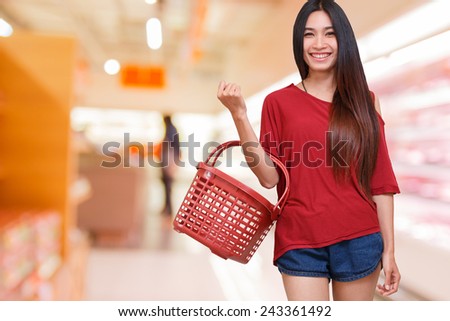 smile lady holding shopping basket in supermarket