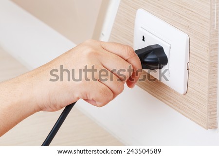 Unplug or plugged in concept,hand holding and pull electric plug