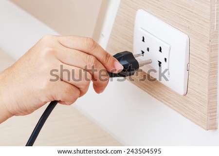 Unplug or plugged in concept,hand holding and pull electric plug