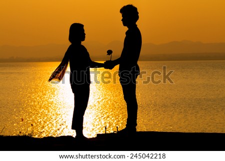 Silhouette of couple in love,Love sensuality and valentine day concept  man hold lady hand at lake side