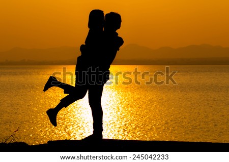 Silhouette of couple in love,Love and sensuality and valentine day concept at lake side