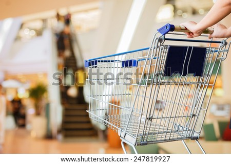 close up woman and shopping cart shopping mall