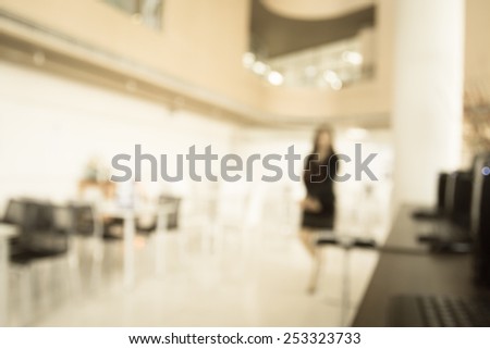 business woman walking in office in blurry for background