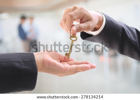 Man giving women a  golden key in office