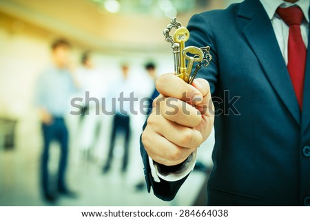 businessman showing the keys to success
