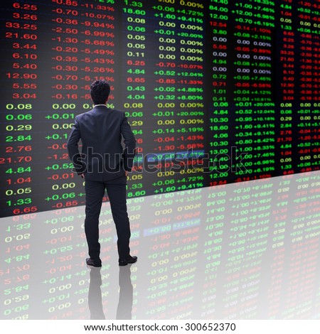 businessman looking to stock exchange market ticker