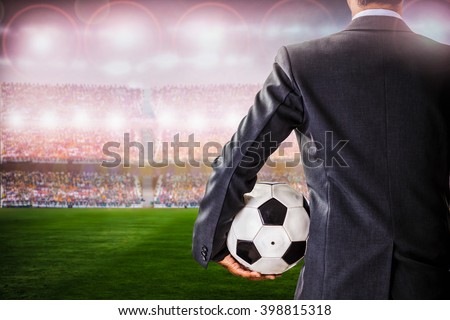 back view of soccer manager against supporters in the stadium