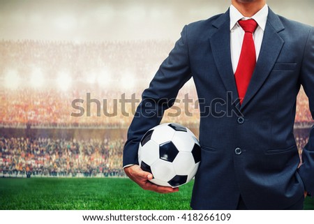 football manager holding soccer ball in the stadium