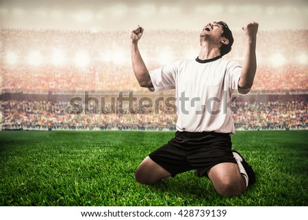 soccer football player celebrating goal scoring in the stadium