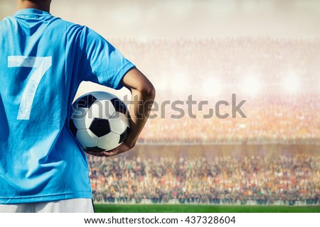 soccer football player in blue team concept holding soccer ball in the stadium