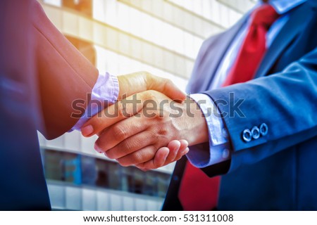 closeup business handshake on building background