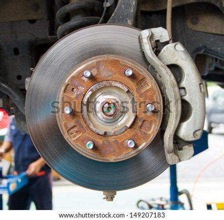 Disc brake and suspension of lifted automobile at repair service station