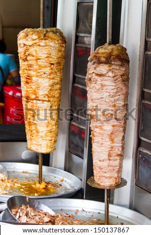 A large piece of   meat cooked in a machine or kebab