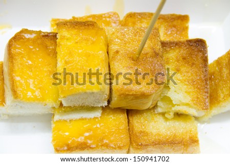 Toasted white bread with orange marmalade on white box