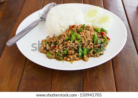 Basil Fried Rice with Pork.Basil fried rice with pork in white dish on wooden table