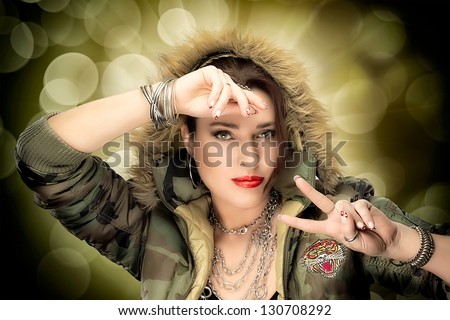 Beauty hip hop woman with camouflage parka with decorated nails and fashion makeup
