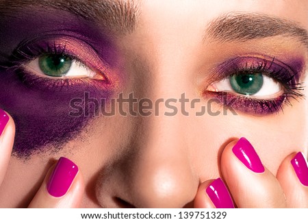 Closeup of Girl\'s Eyes and Nails. Purple and Gold Makeup