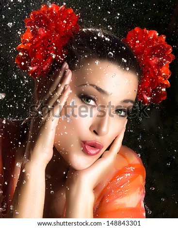 Close up Pretty Young Woman with Red Floral Hair Accessories, Touching her Face with Pouting Lips While Looking at the Camera. Captured in Studio with Water Splash
