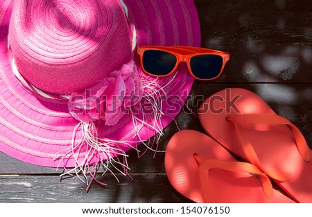 Summer accessories on a wooden background. faded effect