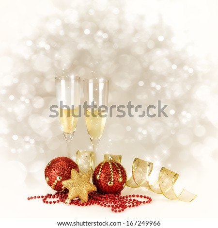 Champagne glasses with Christmas and New Year decorations in gold and red