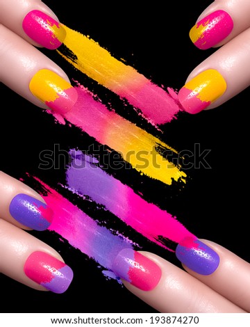 Fingers with red nails and crushed eye shadow with drops of water. Manicure and makeup concept. Closeup image isolated on black