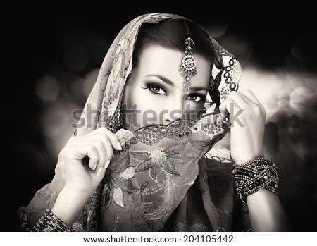 Beautiful hindu woman with traditional clothes, jewelry and makeup. Portrait in black and white