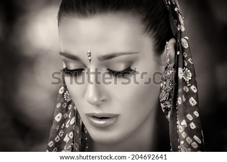 Ethnic beauty. Beautiful hindu woman with traditional clothes, jewelry and makeup. Closeup portrait in black and white