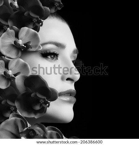 Monochrome portrait of beautiful face woman with flowers. Beauty and makeup concept. Closeup isolated on black background