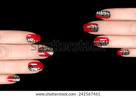 Fashionable nail polish with animal print stickers. Professional manicure and nail tattoo. Nail art concept. Closeup of woman hands isolated on black with copy space