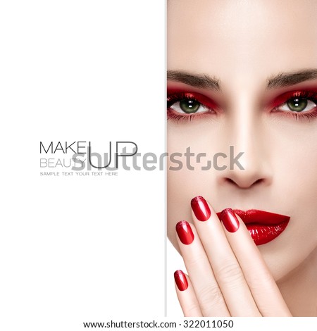 Beauty and Makeup concept. Beautiful fashion model woman with bright make-up. Trendy red lips, nails and smoky eyes. Long eyelashes. High fashion portrait with blank copy space alongside. Sample text