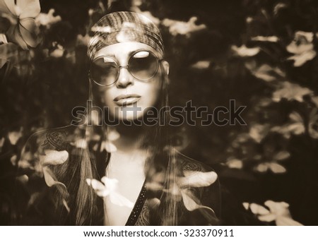 Double exposure portrait of a beautiful girl and flowers. Monochrome portrait of a young woman with hippie style, long brown straight hair, wearing bandana and sunglasses blended nature photography