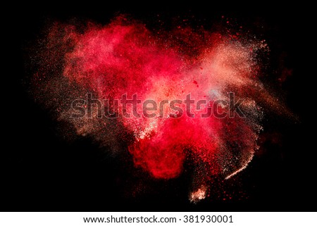 Blue dust particle explosion resembling snow or a pyrotechnic effect over black. Closeup of a color explosion isolated on black