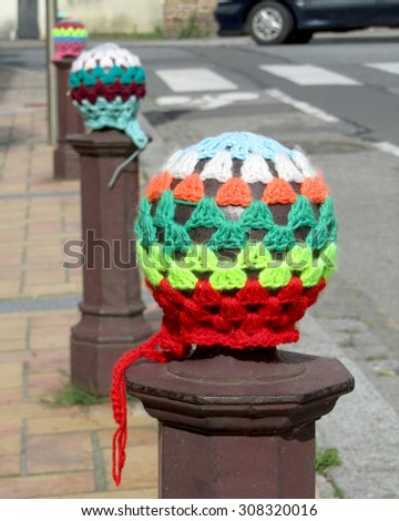 RETIERS, FRANCE, JULY 12 2015: An example of urban knitting or yarn bombing. A type of street art that employs displays of knitted or crocheted yarn. Originated in the U.S, it has now spread worldwide