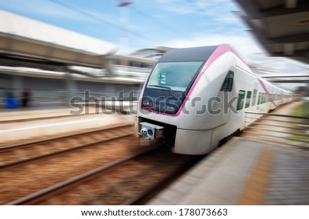 Train approaching railway station with motion blur.