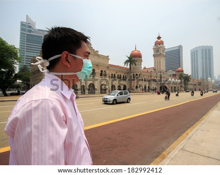 Unknown man wearing a face mask because of thick haze.