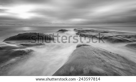 seascape with long exposure on the rocks.  Black and white.