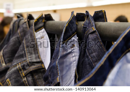 jeans  with hanging rail in a fashion store