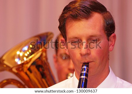 Young man playing clarinet in live orchestral performance