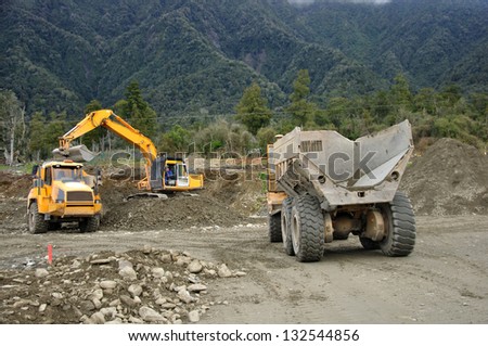 Excavator filling a dump truck at a construction site in Westland