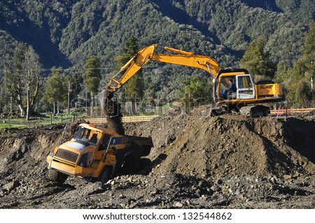 Excavator filling a dump truck at a construction site in Westland