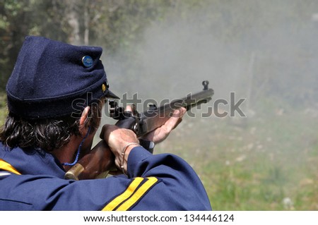 GREYMOUTH, NEW ZEALAND - OCTOBER 24, 2010: Man in civil war costume firing a flintlock rifle at a celebration near Greymouth, New Zealand, 24-10-2010